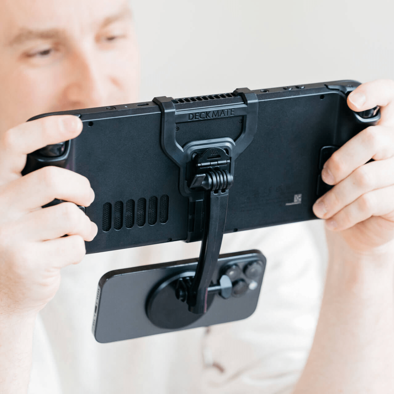 The Mechanism Phone Mount attaches an iPhone below the screen of a Steam Deck