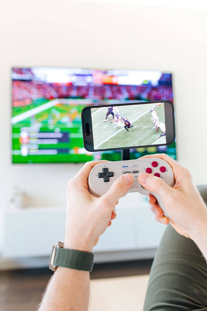 Play your game while you watch the game. Connect any phone to your favorite controller using the Mechanism Phone Mount and Controller Grips