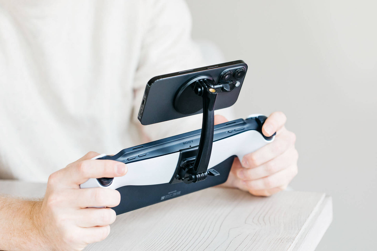 A phone mounted horizontally above a Playstation Portal using the Mechanism Phone Mount.