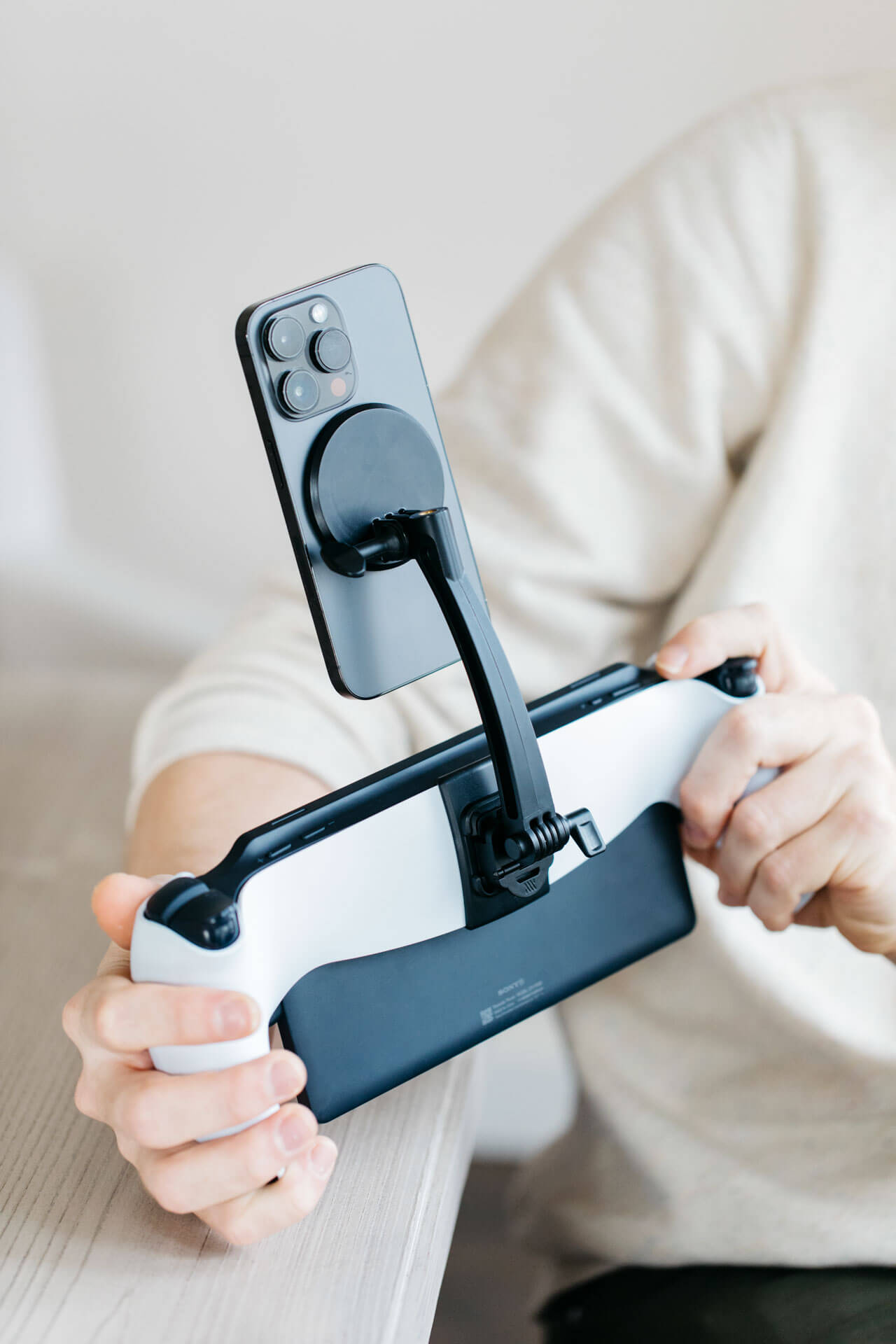 A phone mounted vertically above a Playstation Portal using the Mechanism Phone Mount.
