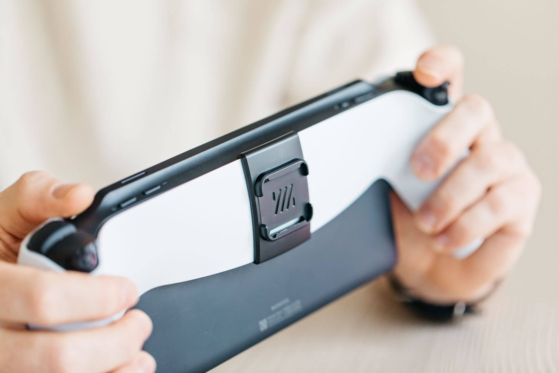 The back of a Playstation Portal with a Mechanism Portalmate attached to the back.