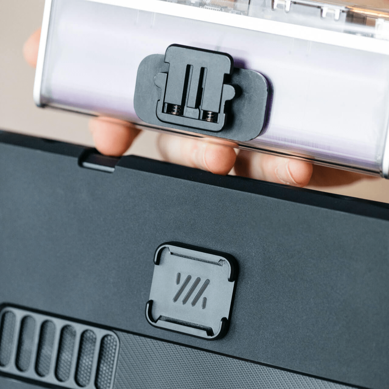 Attach a battery bank to your device using a Mechanism Universal Grip and an Adhesive Mount