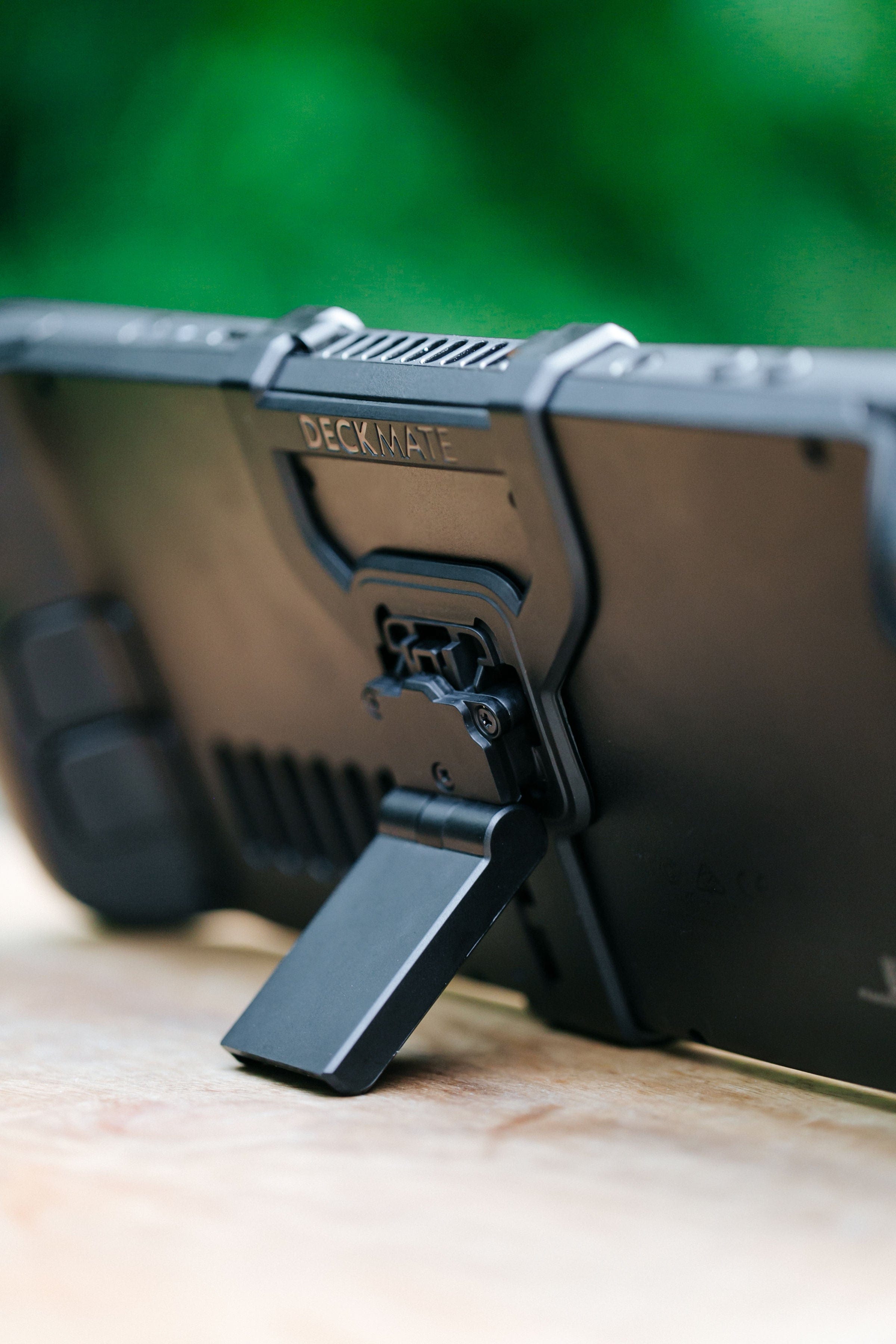 A Steam Deck Propped up using the Deckmate Grip and Kickstand
